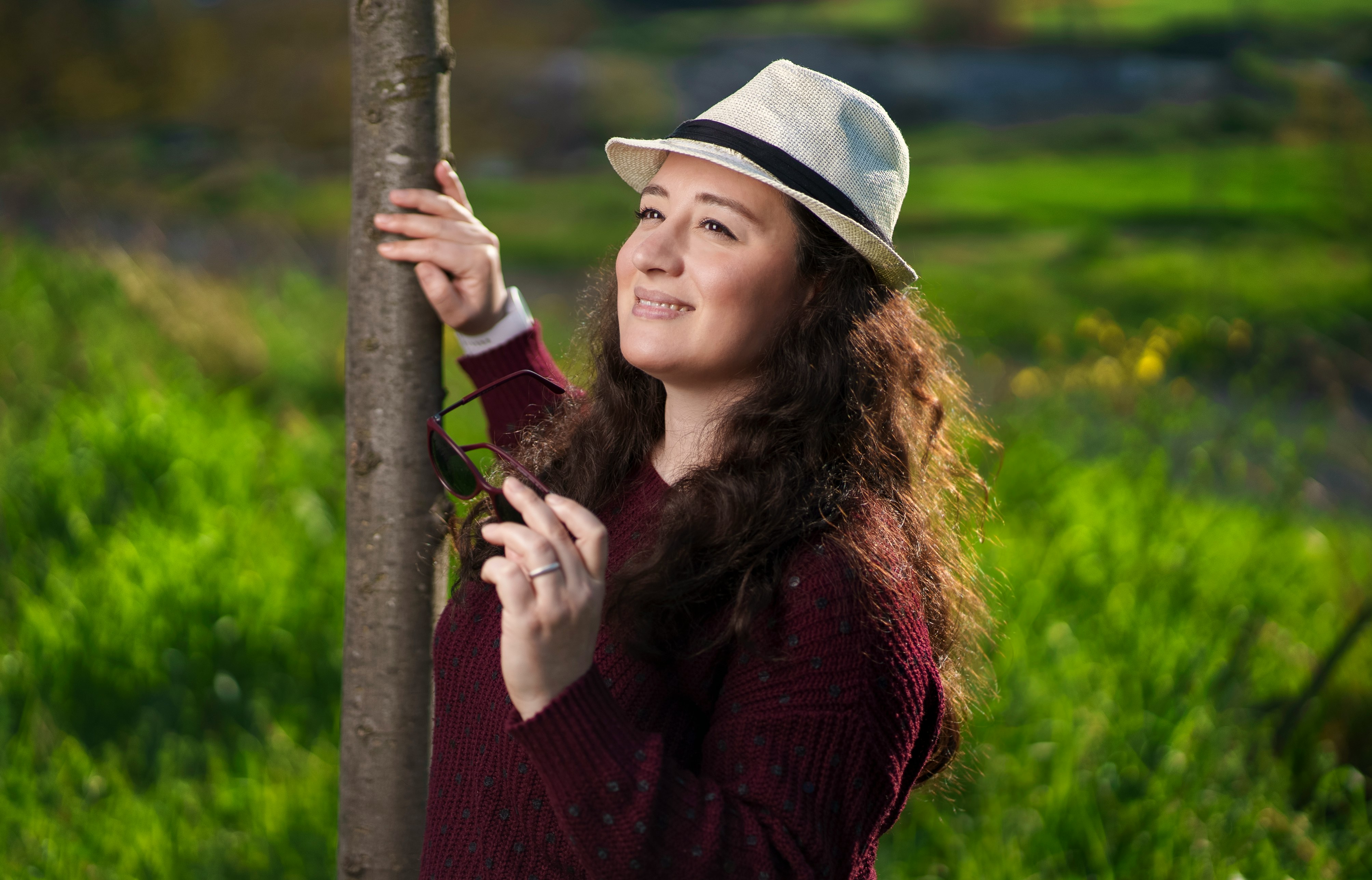 woman in red long sleeve shirt holding gray wooden stick during daytime